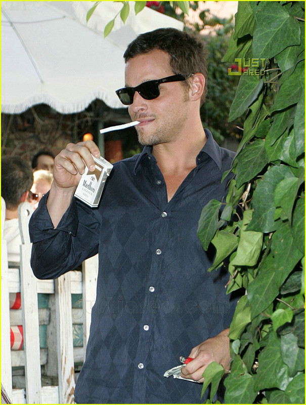 Justin Chambers smoking a cigarette (or weed)
