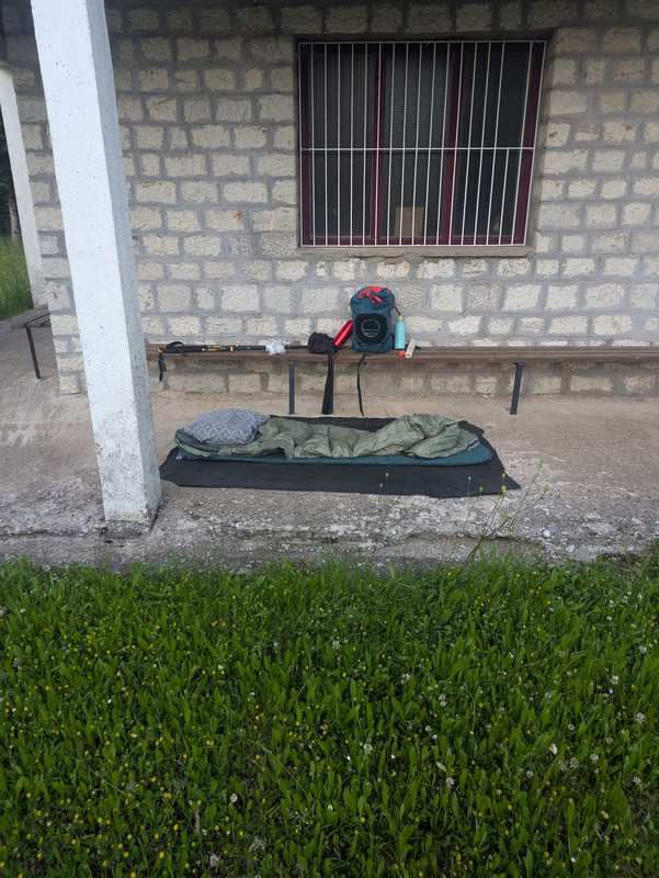 An undermat and sleeping bag laid on a concrete floor