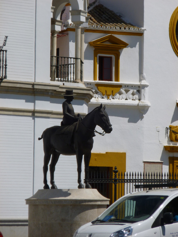 Statue of a woman on a horse.  She is dressed very simply, and wearing a hat.