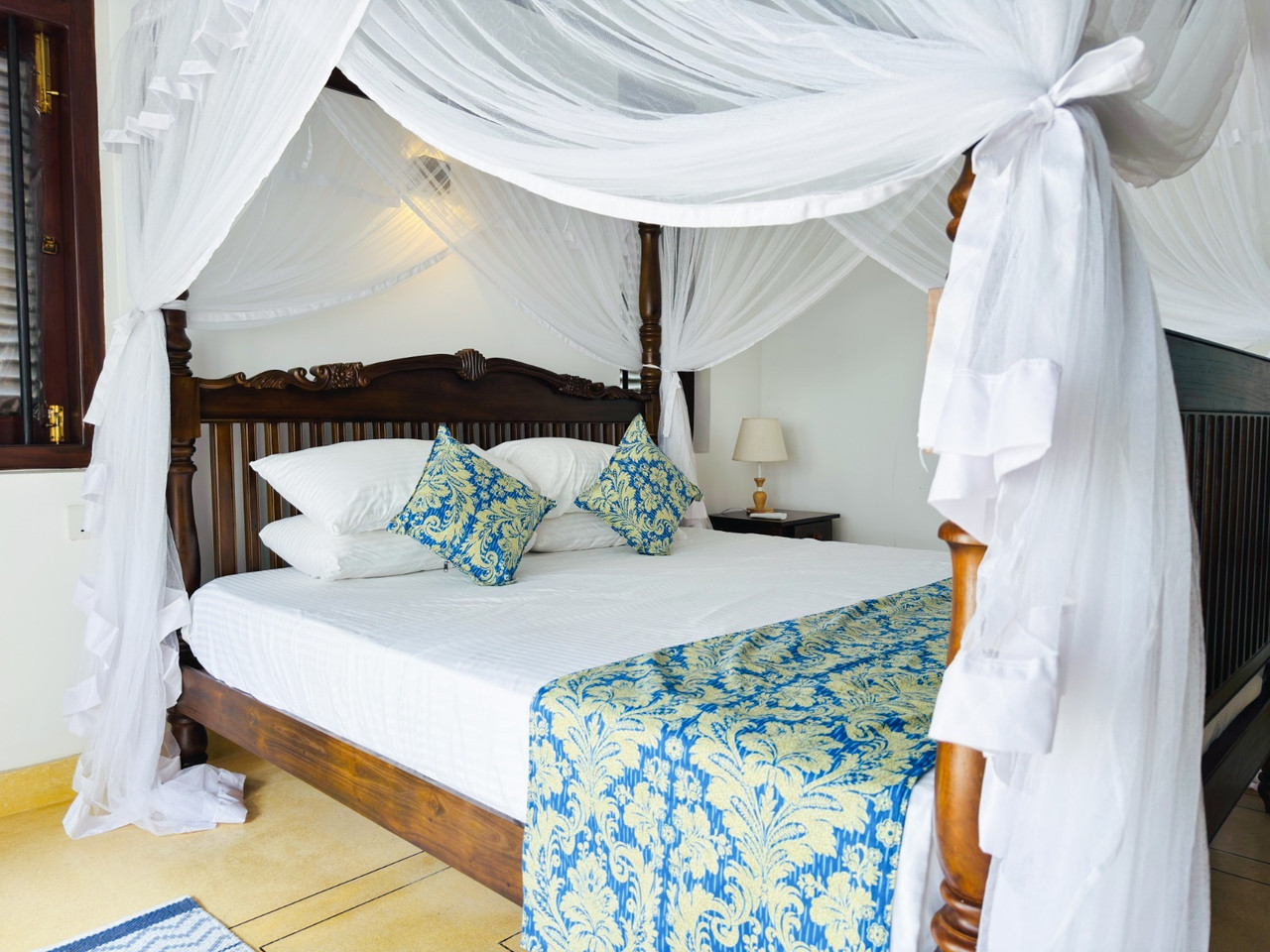 Bedroom with four-poster bed and blue accents