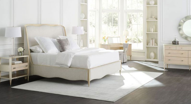 Soft and serene in a light-toned performance fabric, this beautifully upholstered bed engages the senses with a harmonious mix of materials and finishes. Taking a cue from the shapely gingko leaf, it features a gracefully curved headboard, complemented by an undulating footboard and side rails. A Champagne Pearl finish adds subtle shimmer to its wood trim and tapered front legs. The perfect embodiment of casual glamour, with organic, flowing lines inspired by forms in nature.