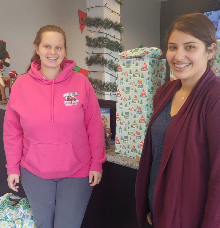 Yesenia Wilhoite, Facility Manager at StaxUP Storage on Hill St in El Cajon posing next to the recipient of her facility's Strat Gifts of Love 2018 donations.