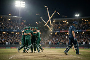 Pakistan fielders celebrating a wicket as England's stumps cartwheel in the Rawalpindi night ODI