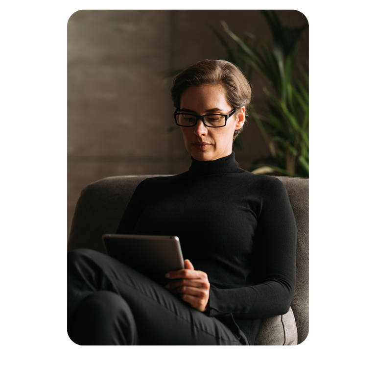 Two coworkers reviewing content on a computer in warmly lit office