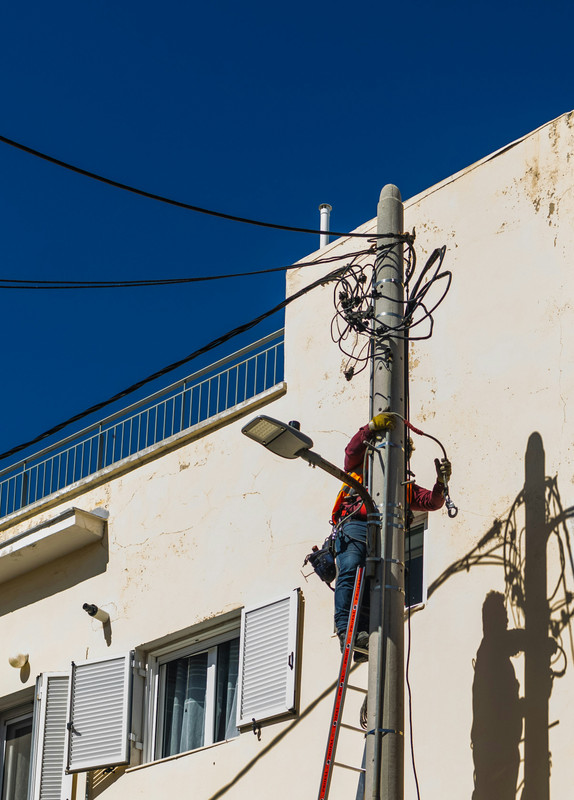 Wind turbines on a hill at sunset.