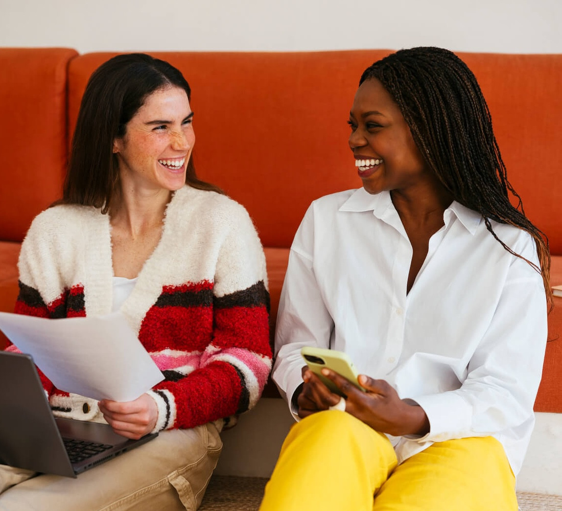 Two people working together on a laptop