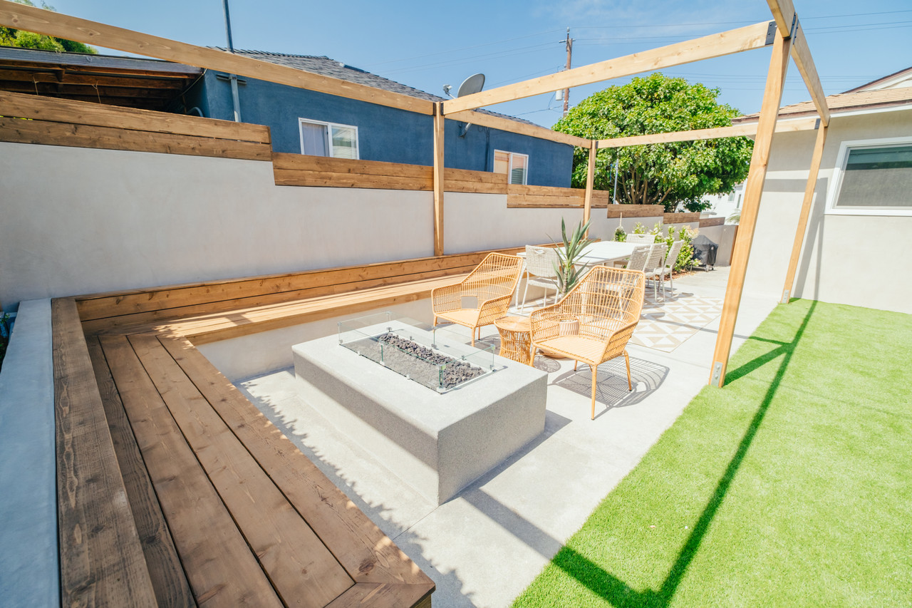 Hillside landscaping with retaining walls, tiered planting and walkway in Palos Verdes