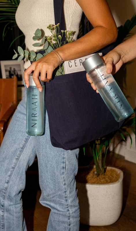 Premium lifestyle tote bag featuring two Niraah bottles
