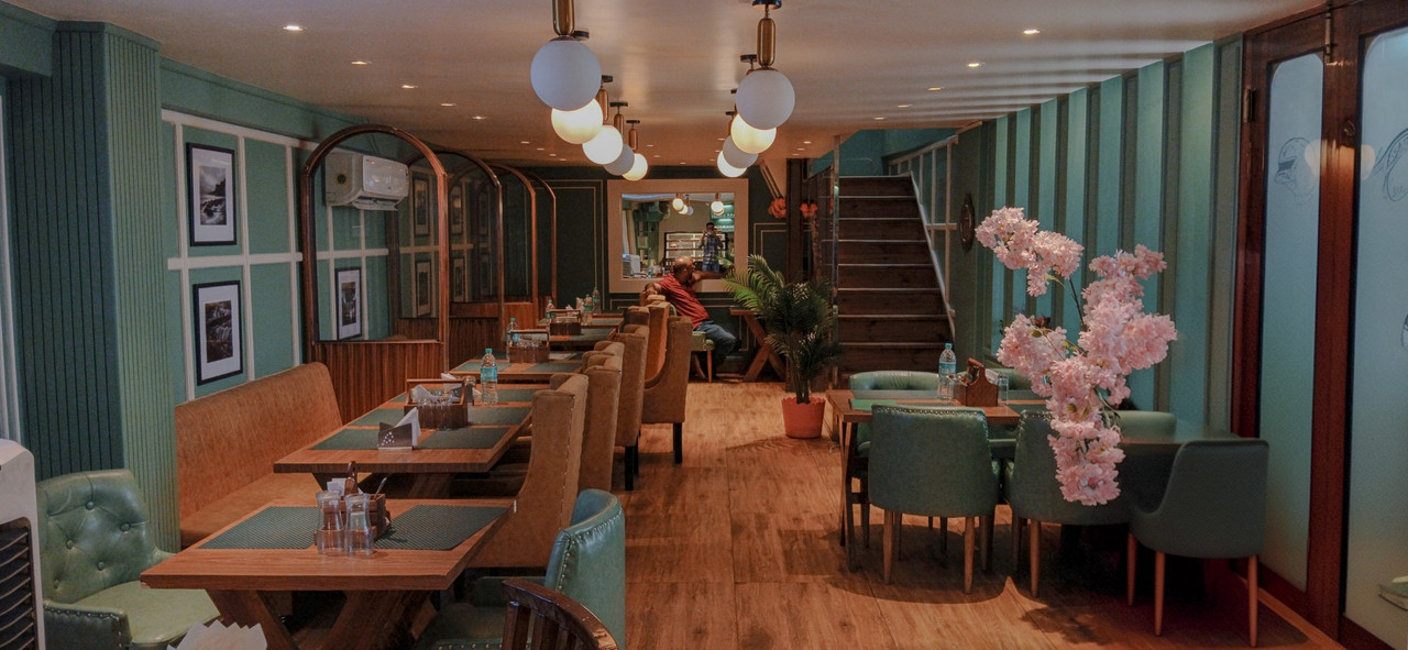 Elegant restaurant interior with warm lighting and beautifully set tables.