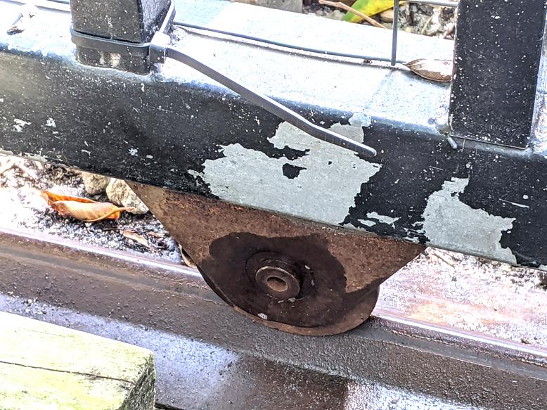 Rolling metal gate roller stuck and won't turn