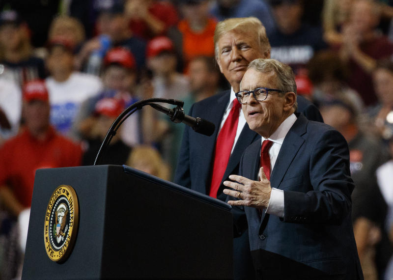 President Donald Trump stands with Mike DeWine as he speaks during a rally, at the IX Center, in Cleveland, in 2018.