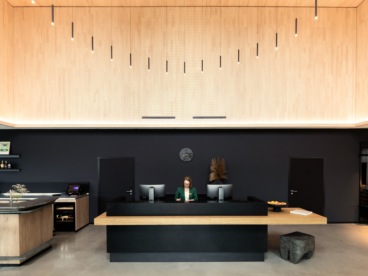 Coreum Hotel reception with architecturally integrated lighting and a circular bespoke luminaire