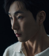 Exterior of Na Baekjin's modern minimalist house in Seongbuk-dong – pale concrete facade with warm wood panels and large windows