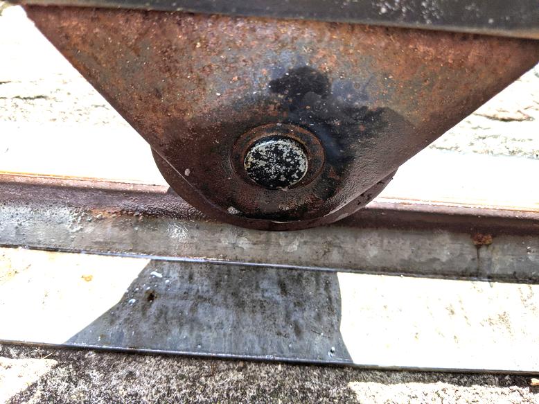 Rolling metal gate roller stuck and won't turn