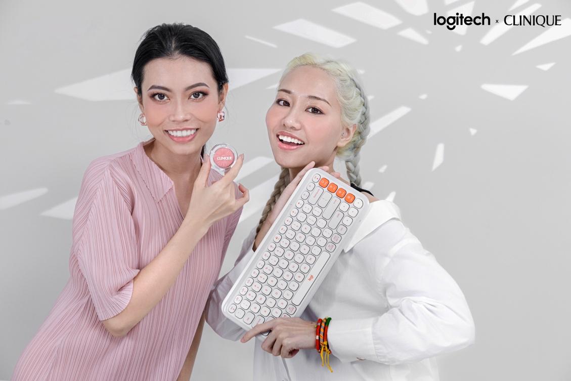 Two women holding a keyboard and a keypadDescription automatically generated Two women holding a keyboard and a keypadDescription automatically generated