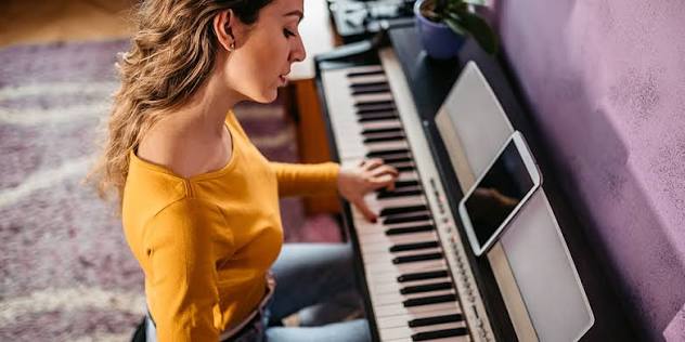 foot pressing a digital piano sustain pedal