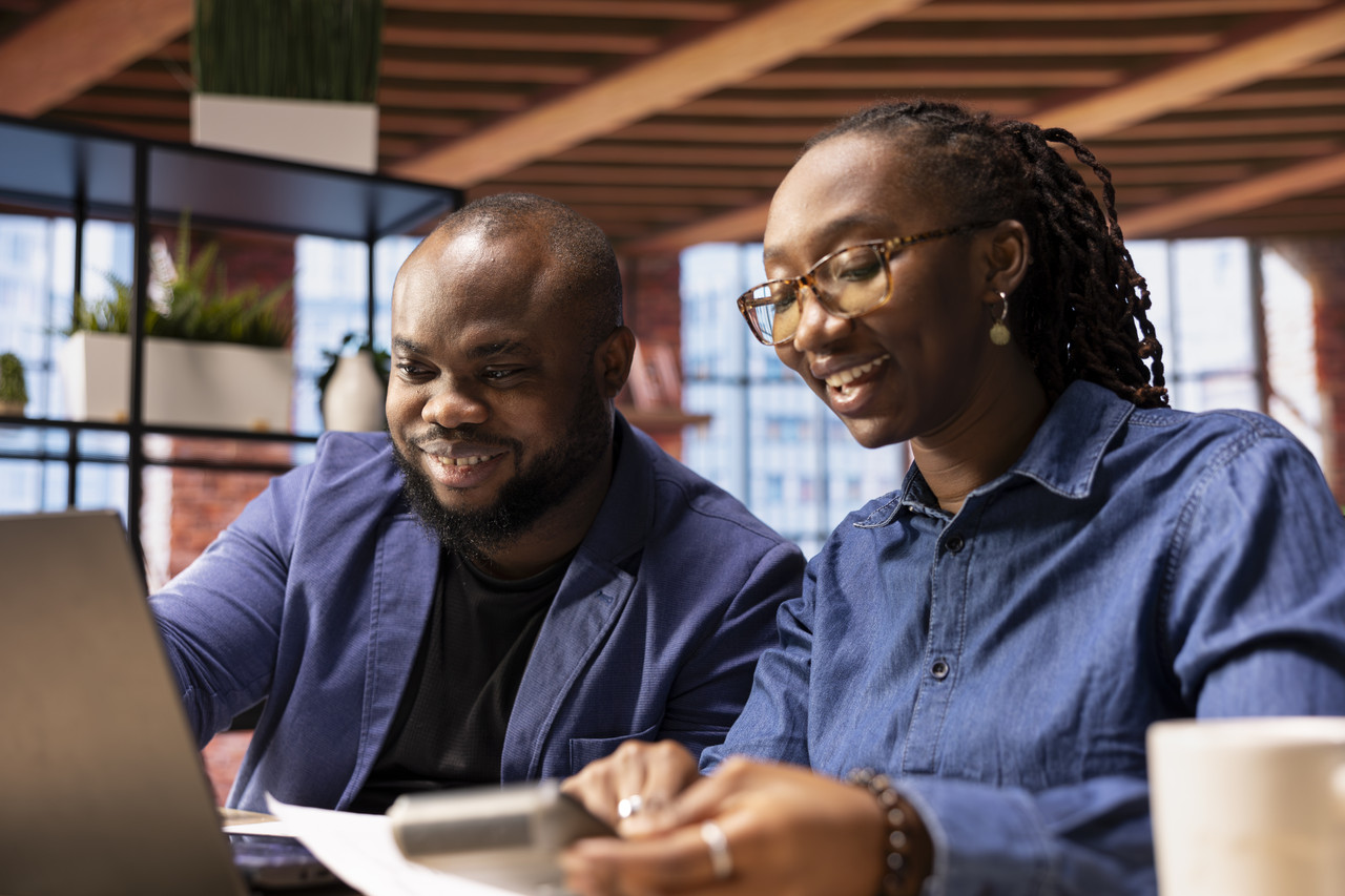 Consultants reviewing earnings and revenue reports together
