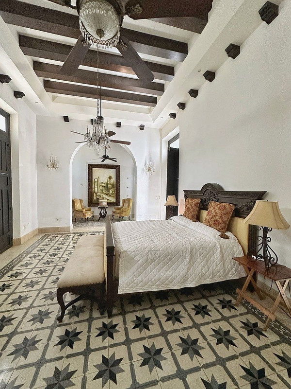 Master bedroom with wooden beam ceiling at Villa Sofía