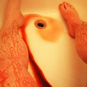 Close-up of Legs with fake blood going down the drain