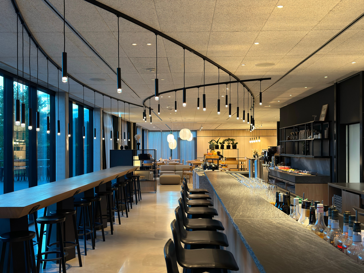 Bespoke black metal and glass lighting installation above the Coreum Hotel bar