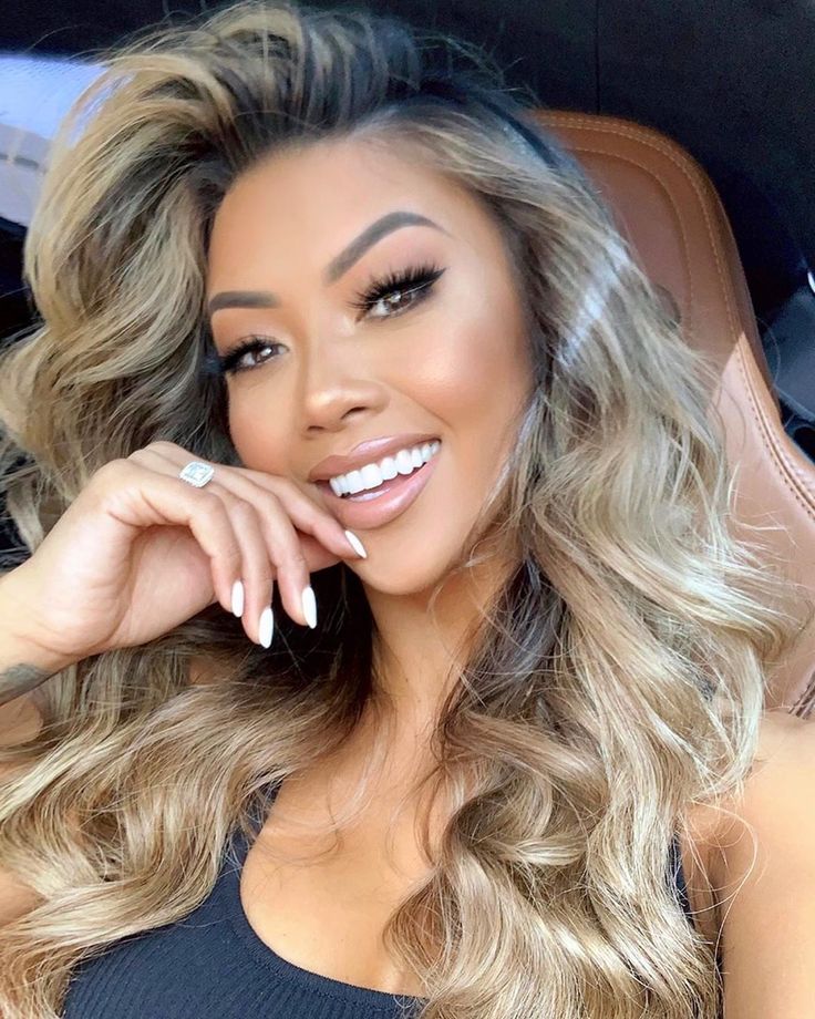 Long strong slightly curly blonde hair on brunette with dark skin tone, brown eyes and a beautiful smile