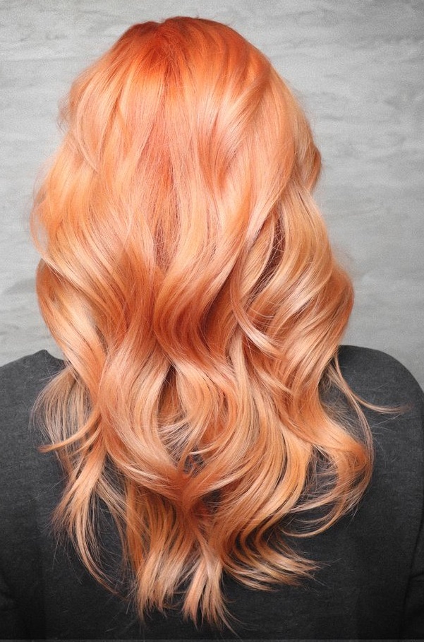 Long wavy hair colored in golden melon color