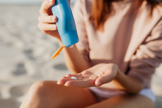 a woman applying sunscren to protect her skin barrier 