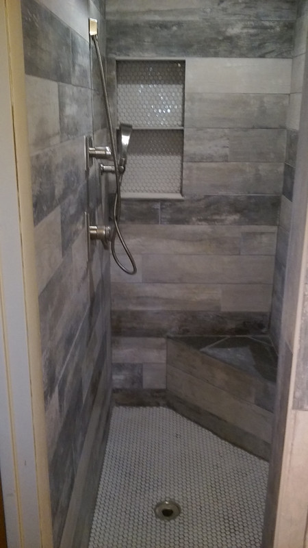 shower surround with wood looking tile porcialen 4x24 on shower walls and 1x1 tiles on floor 