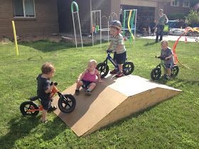 kids are playing their bikes on a bike ramp.