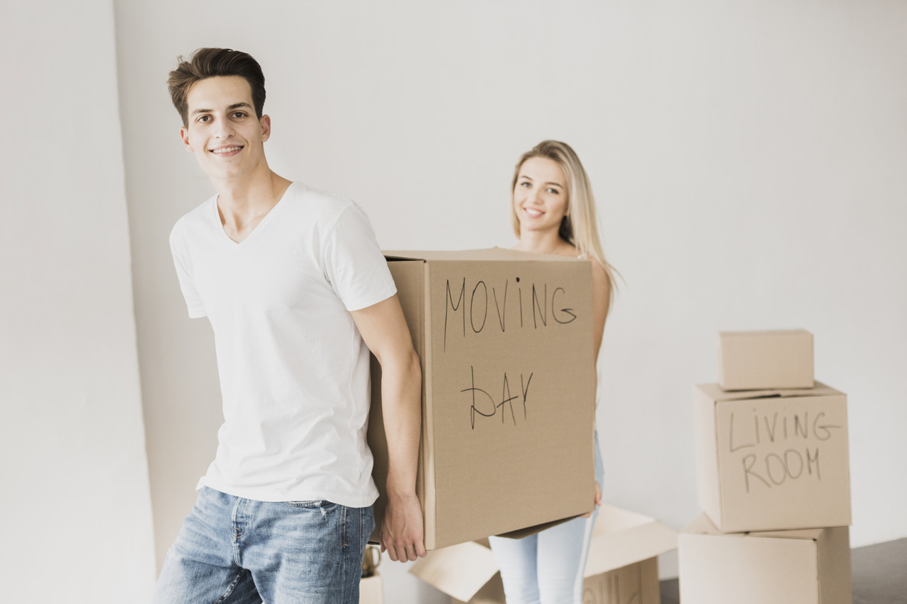 front view couple carrying carton box
