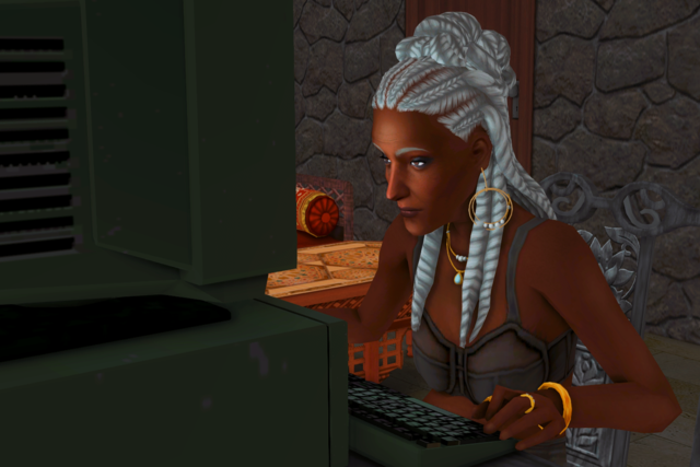 Olive looking closely at a computer screen in the dark