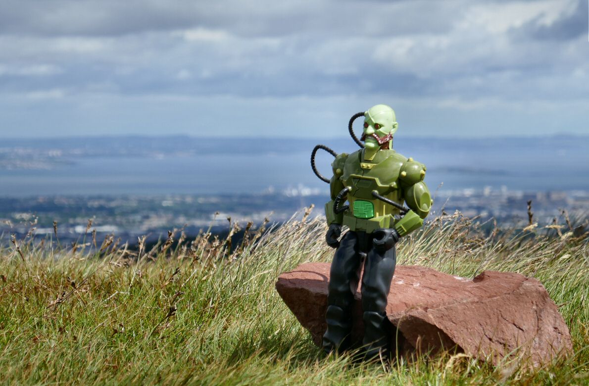 Green robot reaches a rock on the top of very windy Harbour Hill. ABFBE96-E-25-E6-447-B-9-CDF-8-E82-C5-F46-C73