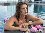 Man-resting-on-pool-edge-202605112235-(1)