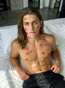Man-biting-lip-on-bed-202605112239