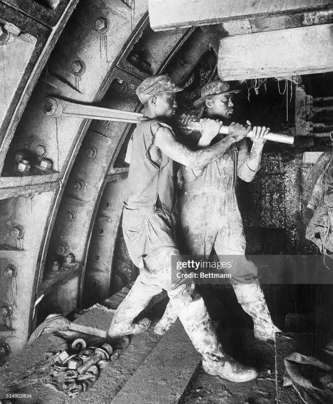 august-20th-1924-two-construction-workers-tighten-a-rivet-v0-5exlnfcyesjd1