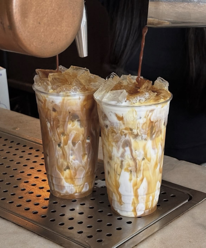 Two large, sugary iced lattes with cream and caramel drizzle