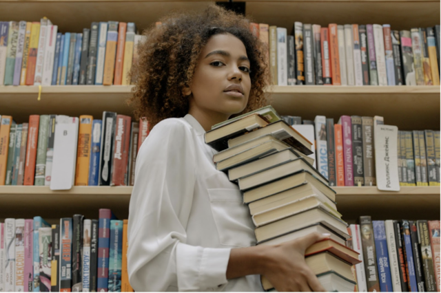 A Woman Carrying Books with Her