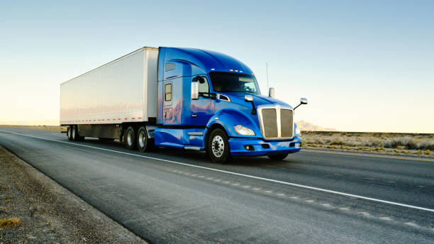 SJH Logistics blue semi truck on highway