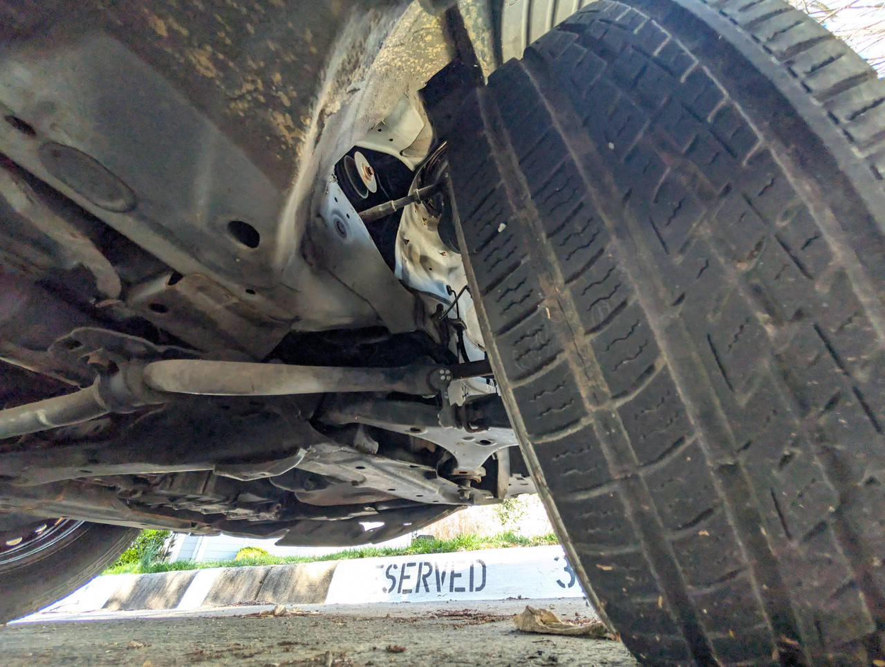 Under Passenger Front Wheel