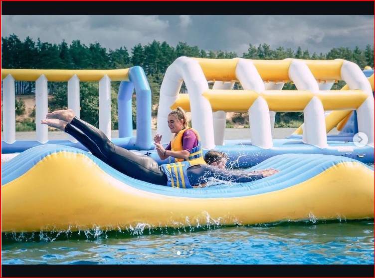 2 Adults Sliding on Wave