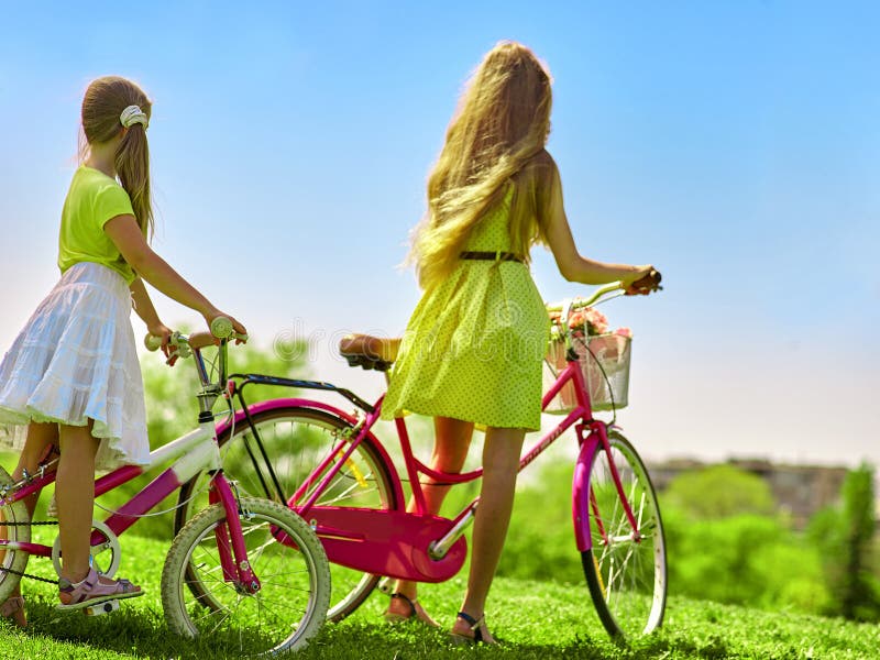 girl-wearing-red-polka-dots-dress-rides-bicycle-park-bikes-teenager-child-yellow-keeps-flowers-baske