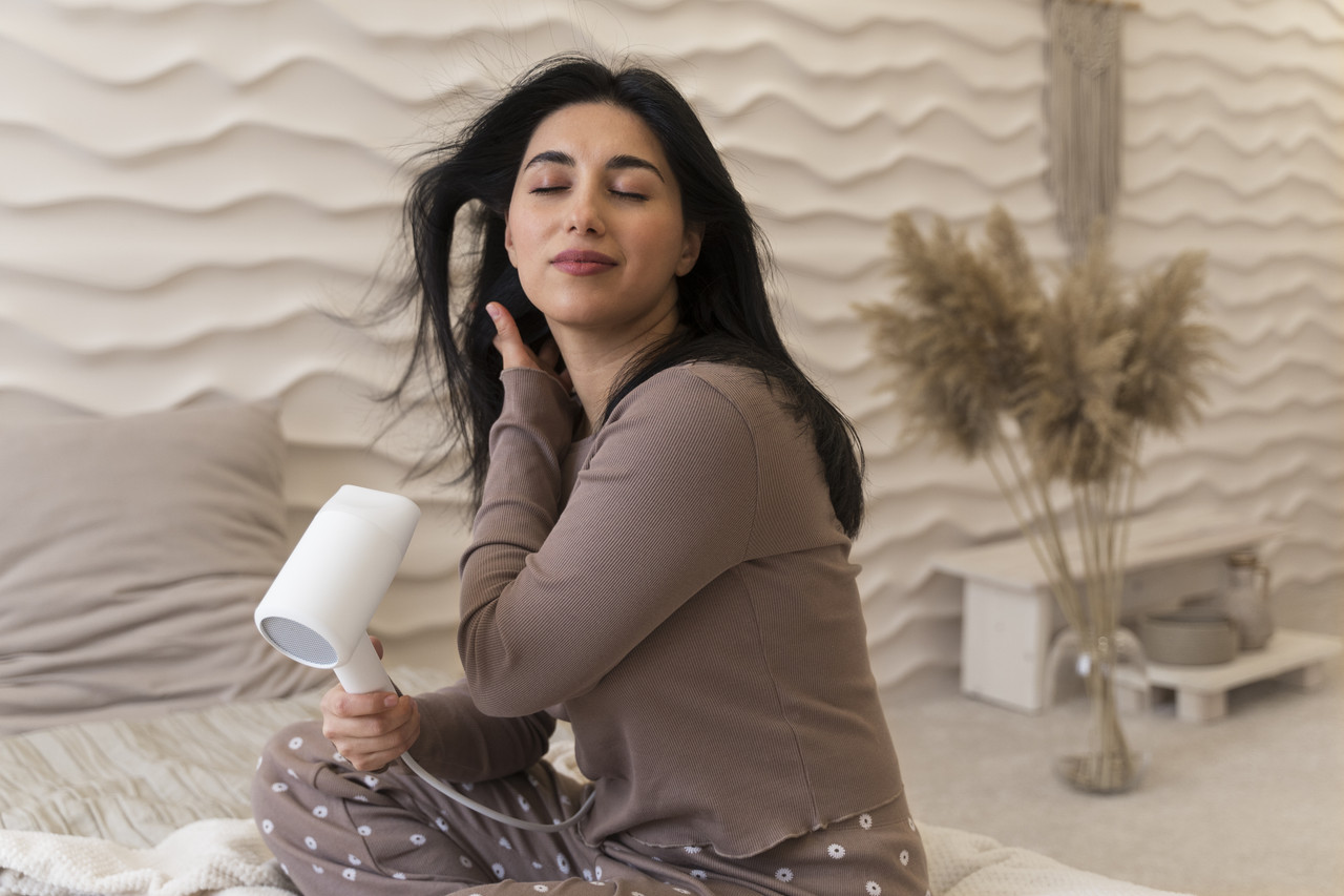 woman using hairdryer her beauty routine (3)