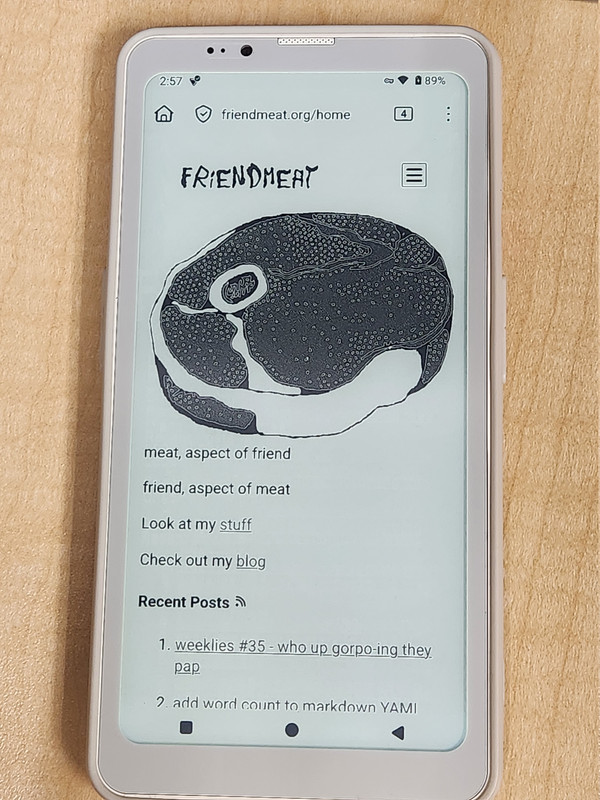 photo of an e-ink phone displaying the homepage from friendmeat.org
