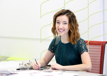 Student working at desk performing administrative work.