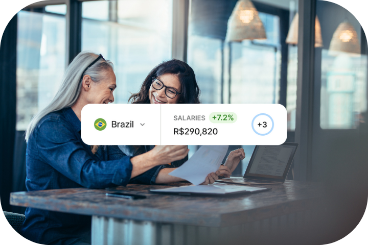 Man reviewing sticky notes posted on a glass wall