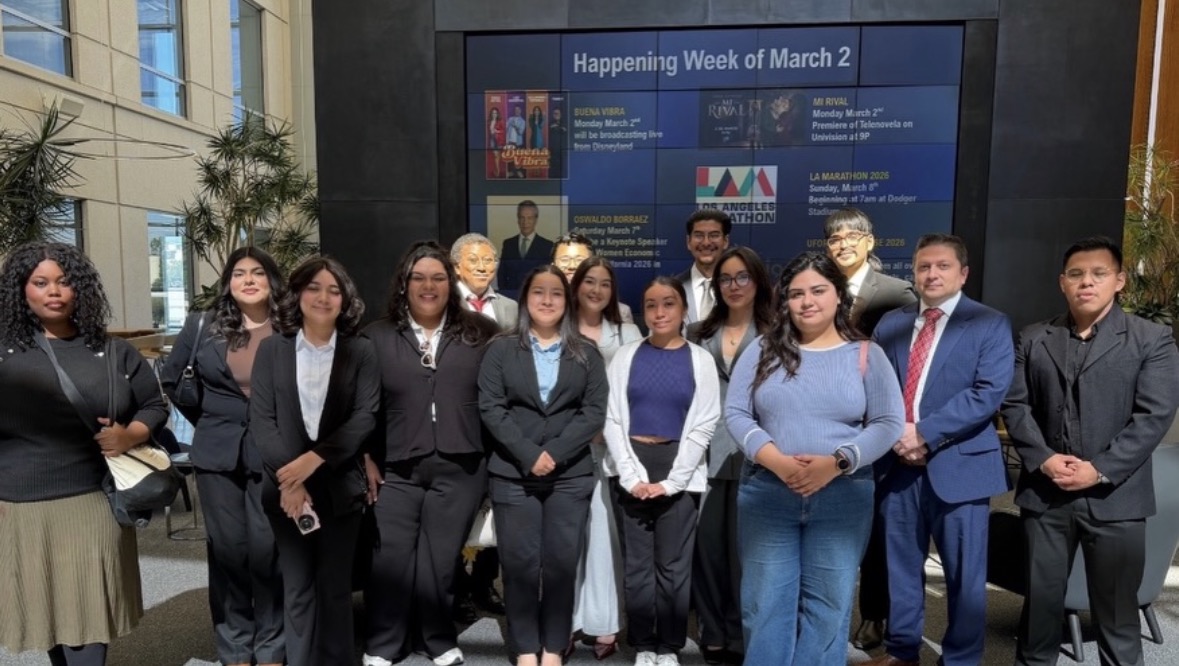 LSBA members standing in front of a large campus TV display.