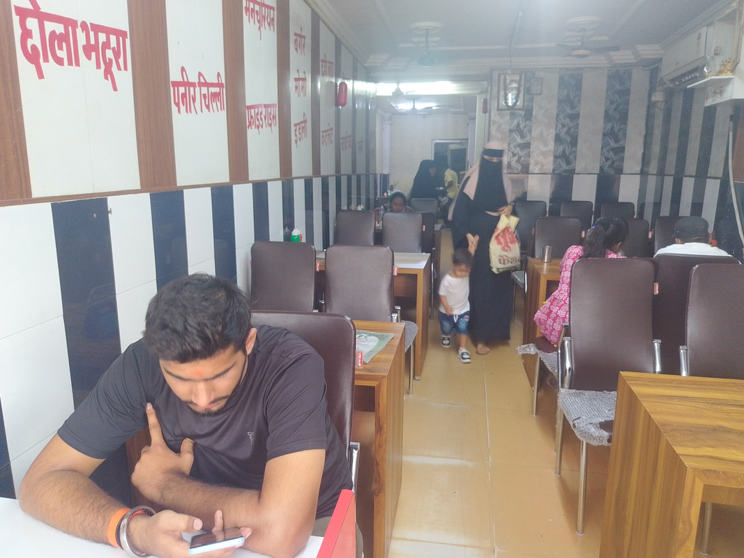 Chefs preparing traditional Indian dishes in a modern kitchen with spices and fresh ingredients