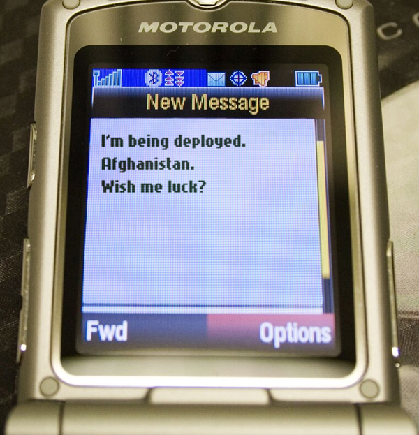 text message on a classic Motorola phone. It's from Jack telling Robby that he's being deployed to Afghanistan