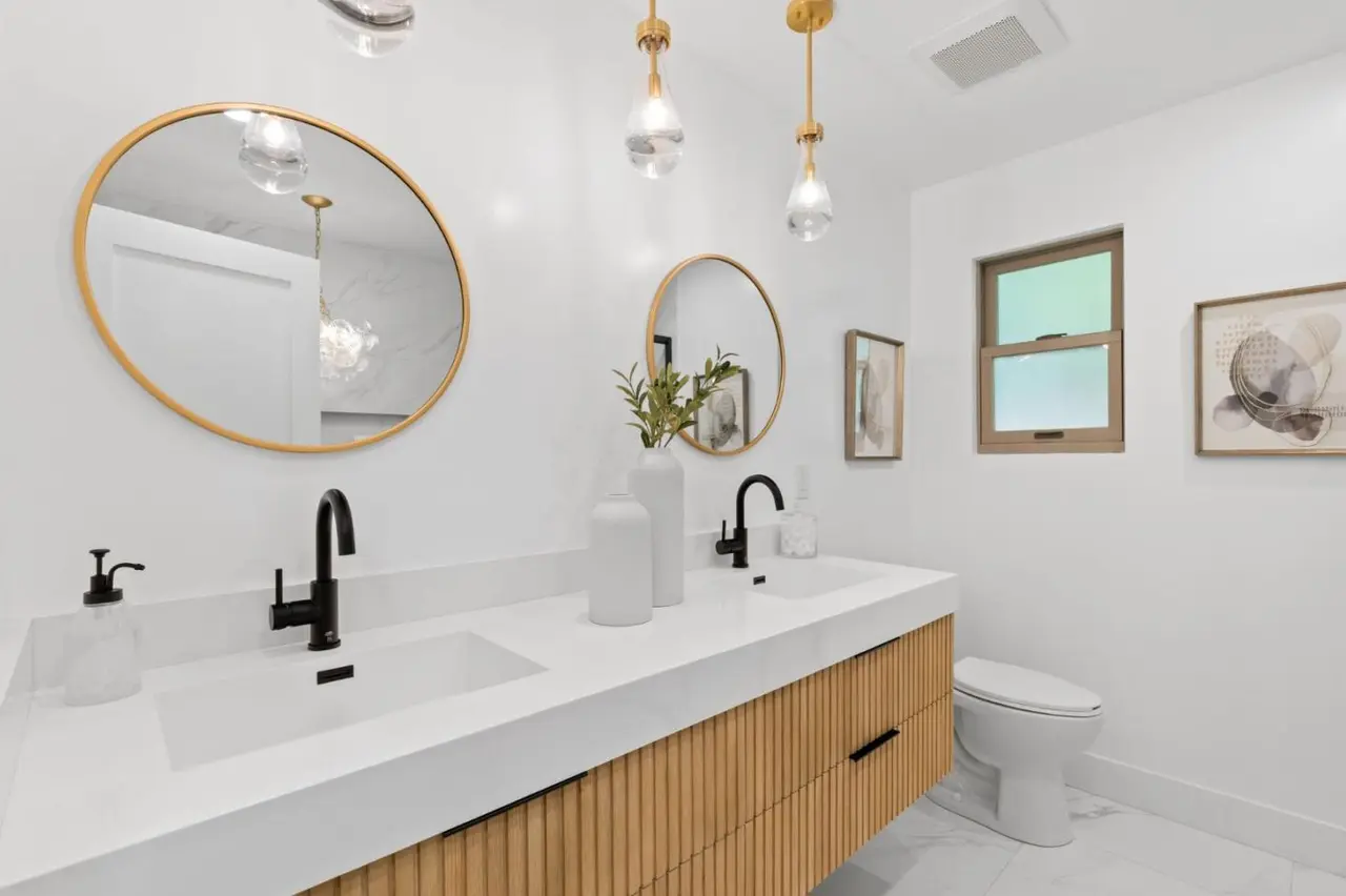 Primary bath with double vanity and bright backlit mirrors