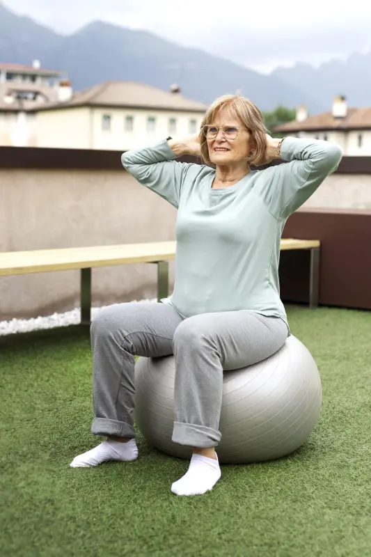 Elderly woman sitting on an exercise ball